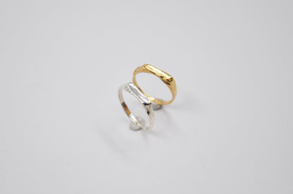 Gold and silver rings on a light gray background