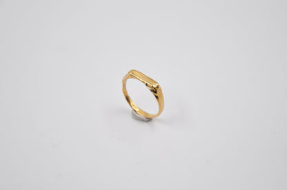 Gold ring on a light gray background