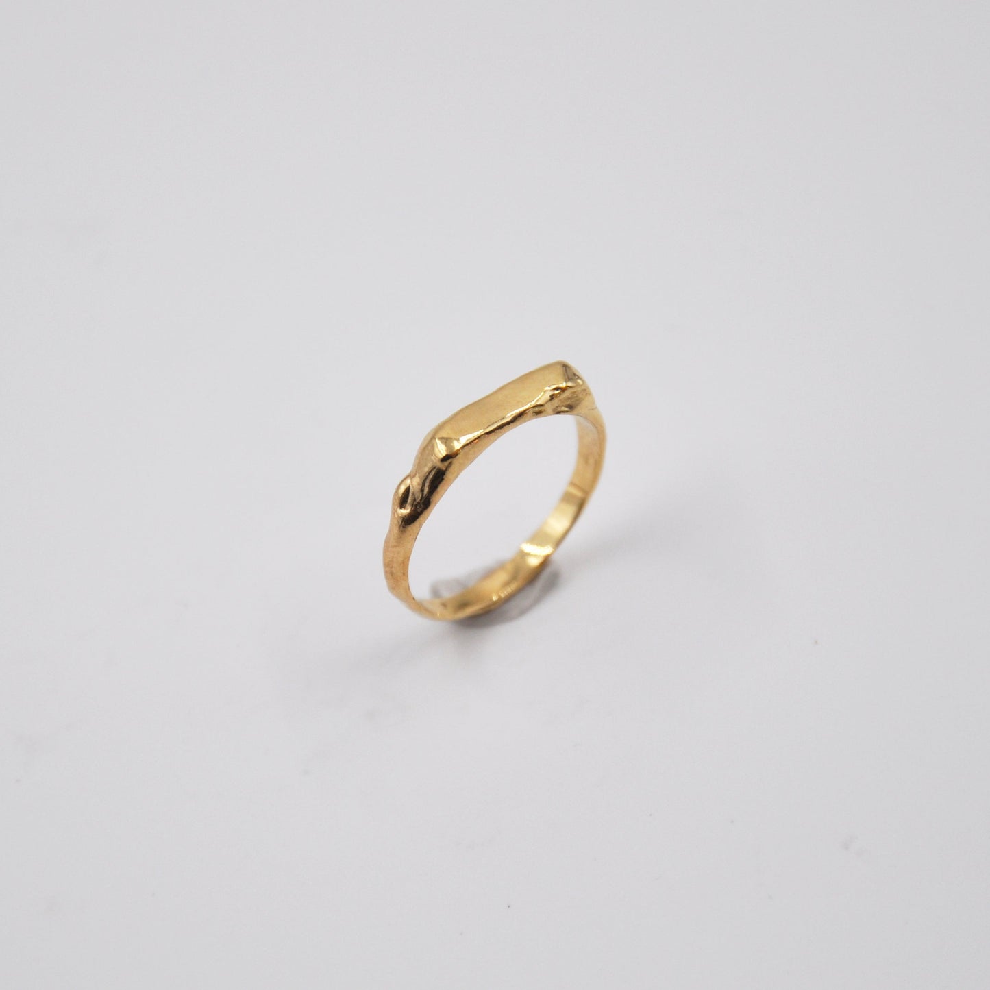 Gold ring on a light gray background