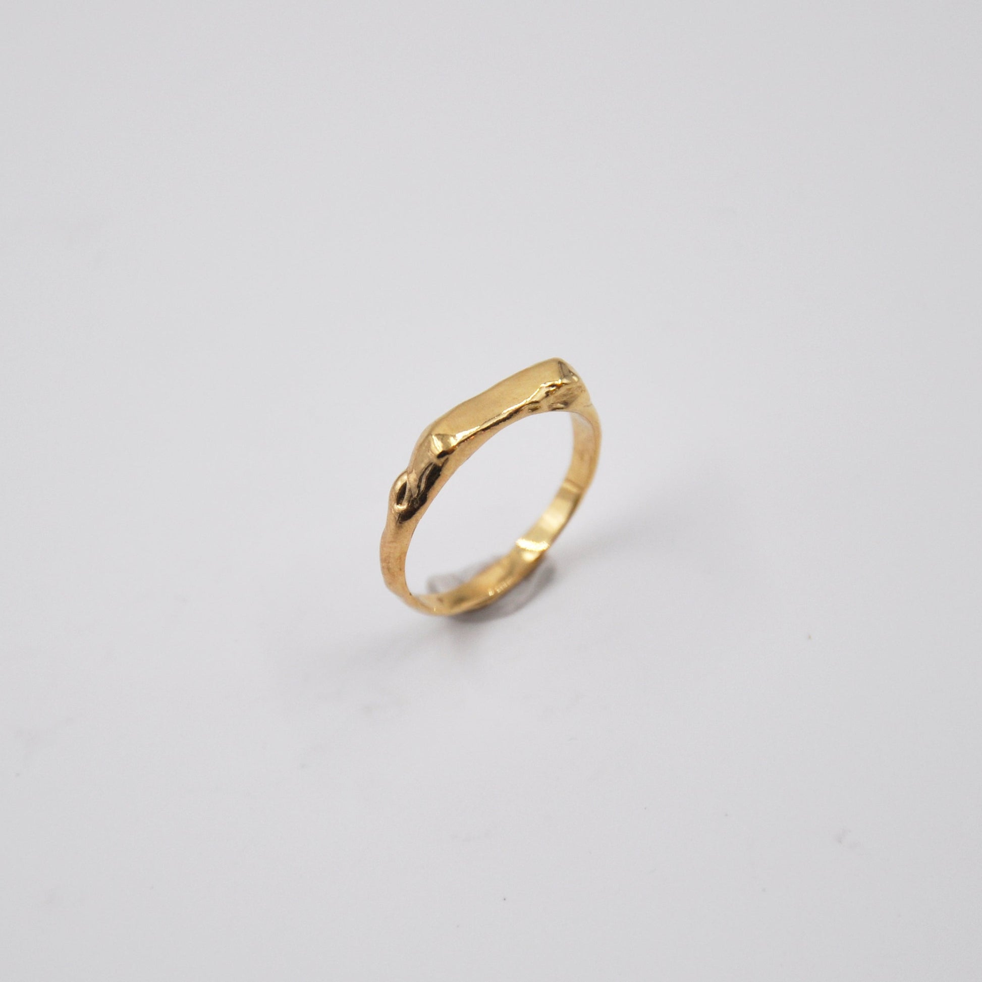 Gold ring on a light gray background