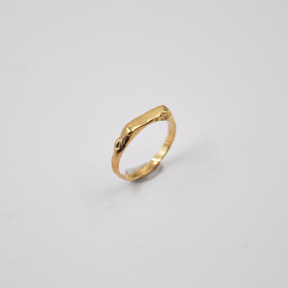 Gold ring on a light gray background