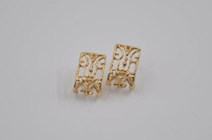 Pair of gold earrings on a light gray background