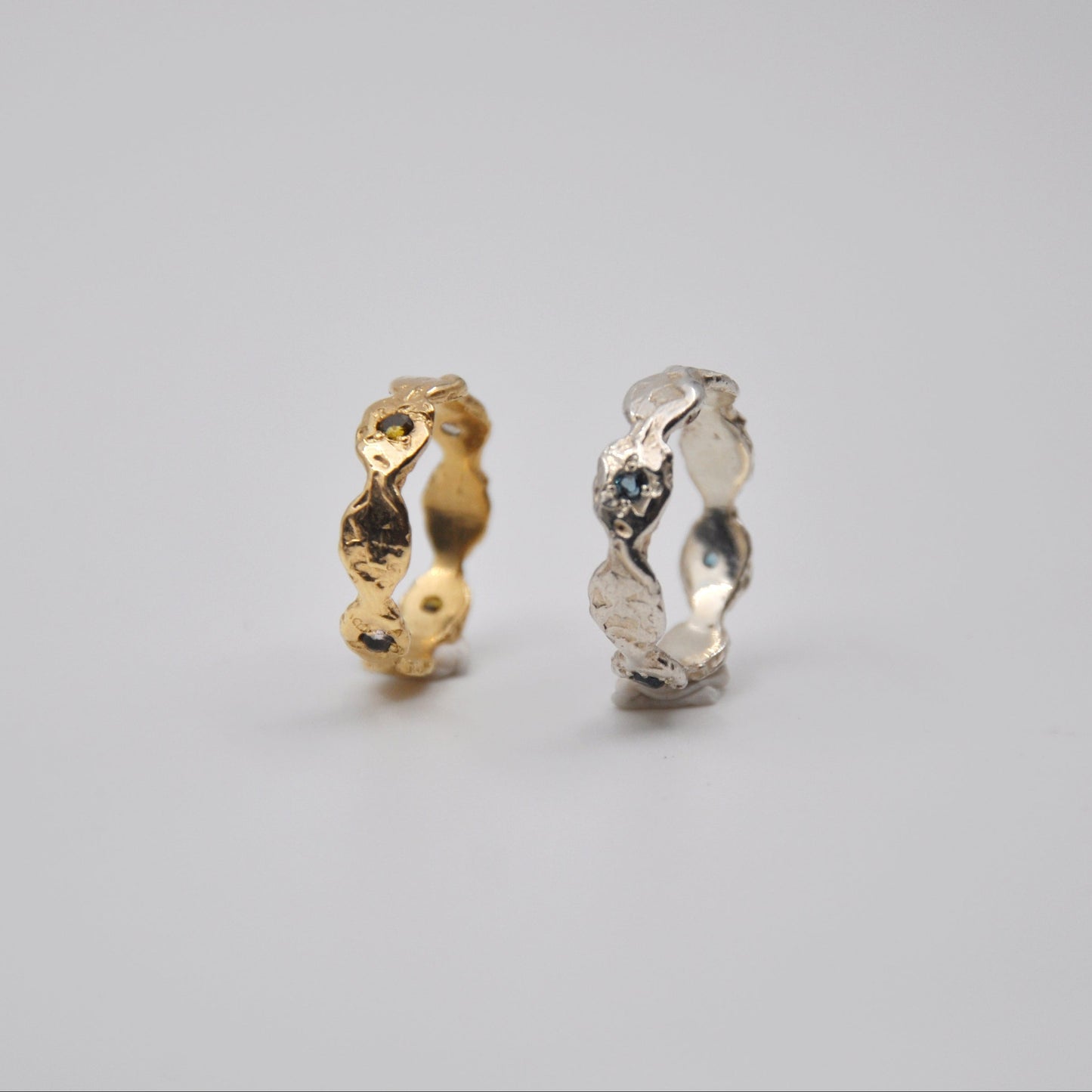 Two gold and silver rings on a gray background