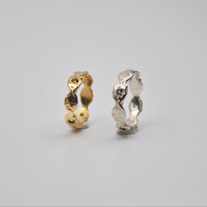 Two gold and silver rings on a gray background